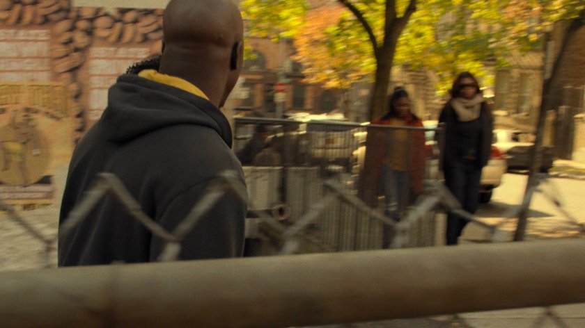 Luke and Misty exit Harlem alley onto sidewalk.