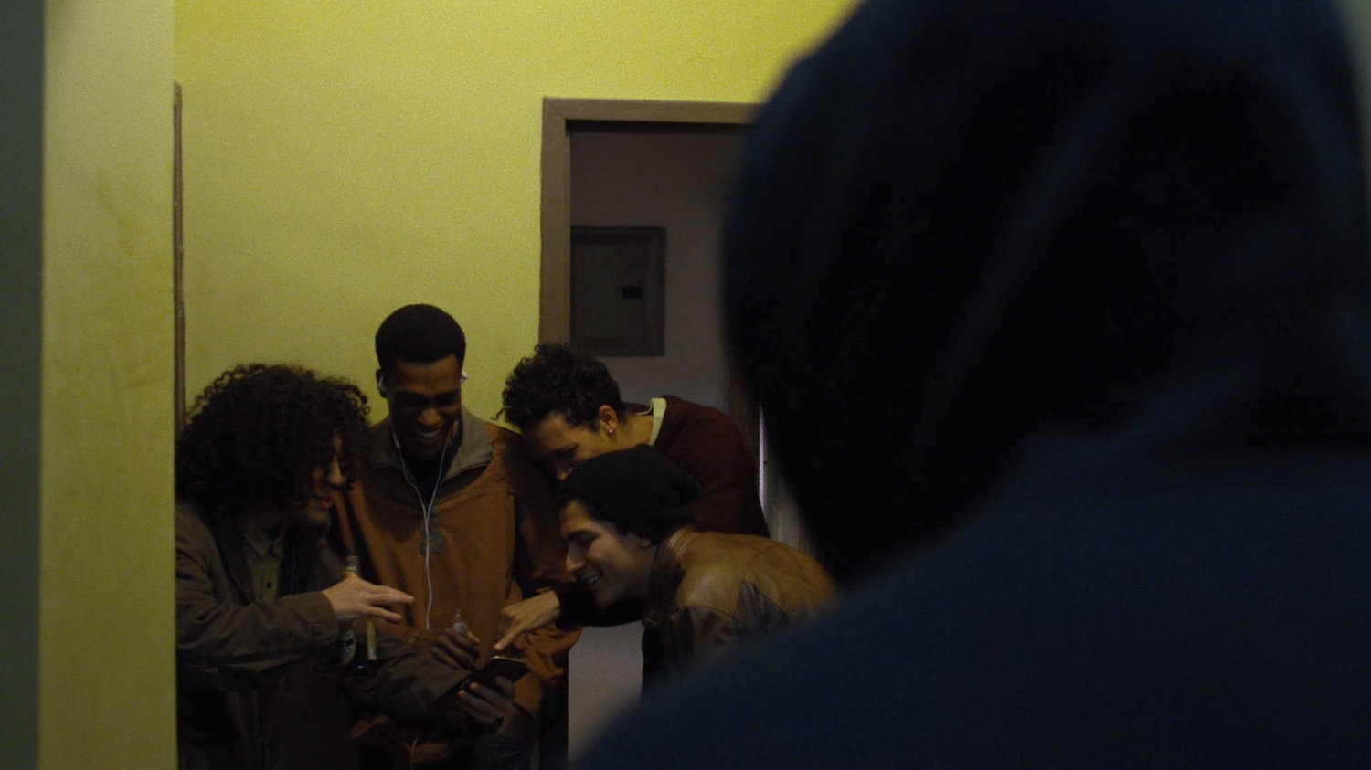 Men standing outside an apartment in Cole Miller's building.