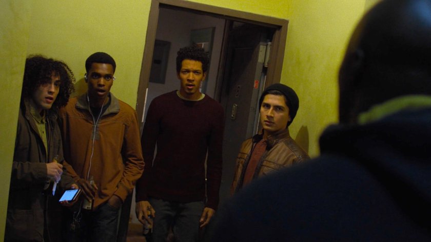 Men standing outside an apartment in Cole Miller's building.