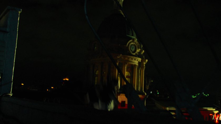 Matt leaping past a clocktower across from his rooftop