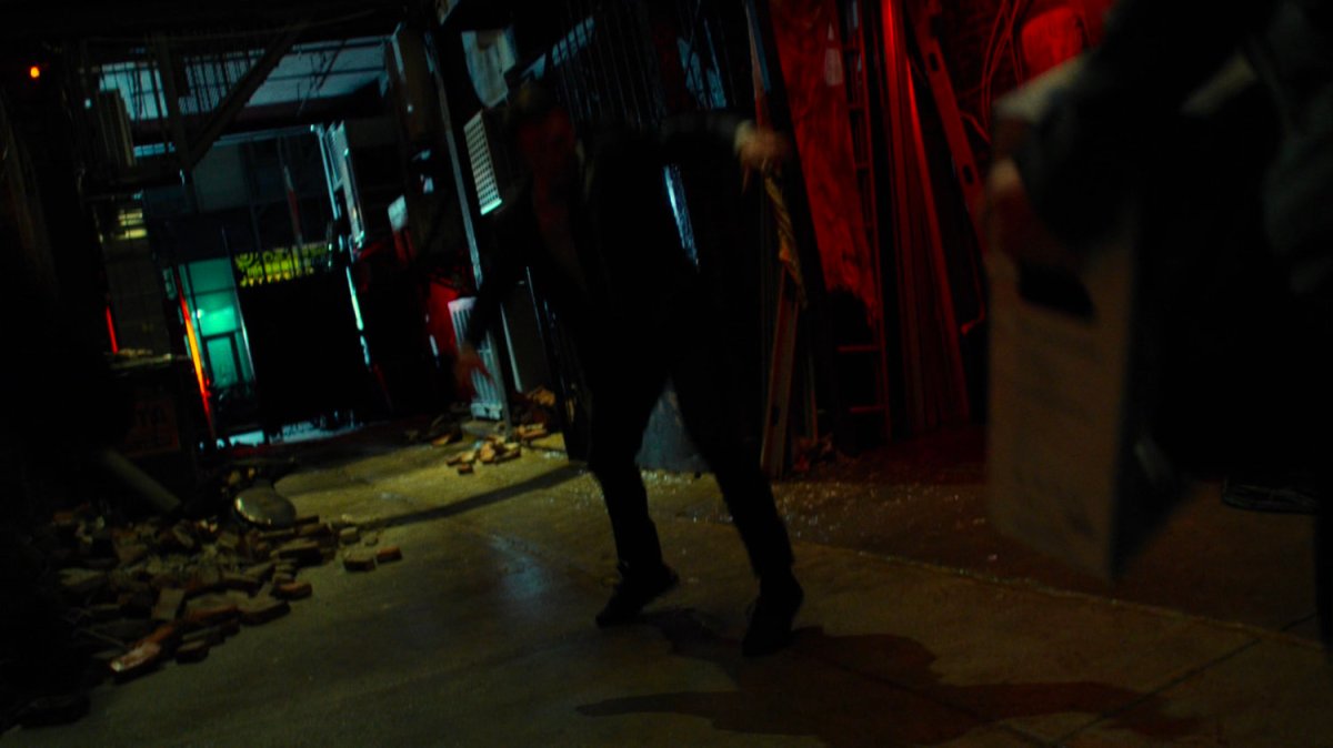 Matt landing in an alley outside a pawn shop exit.