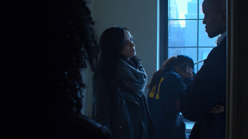 Jessica Jones and FBI agent in John Raymond's motel room.