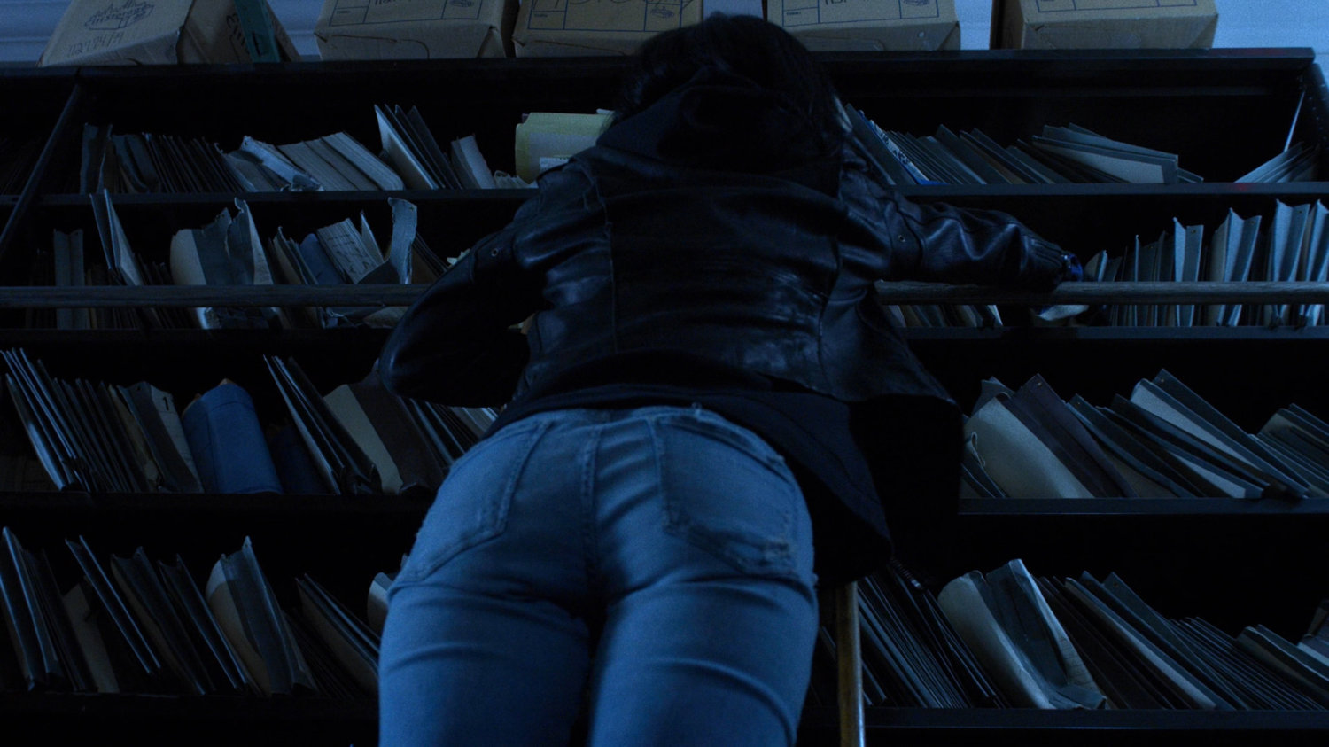 Jessica looks through records in the New York Archives.