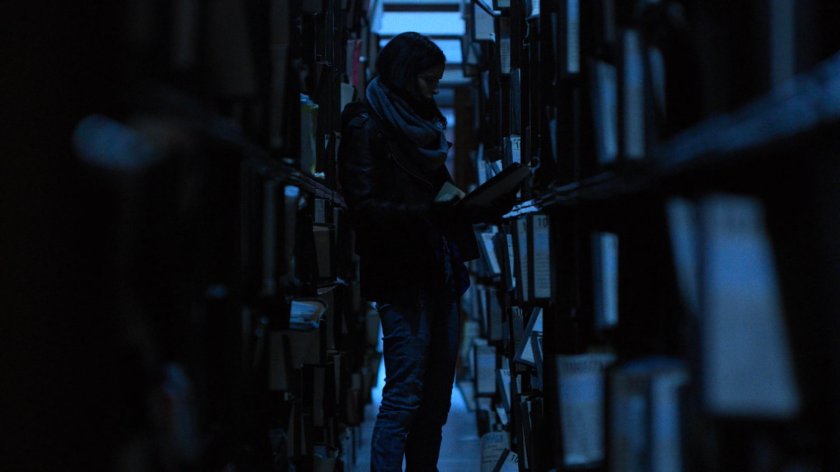 Jessica looks through records in the New York Archives.