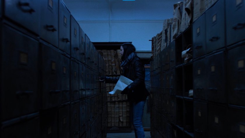 Jessica closing a file cabinet in the New York Archives.