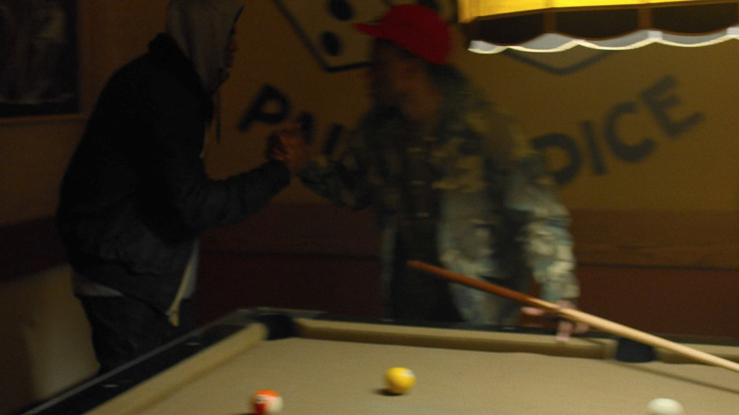 Pool players in the Trouble and a Pair of Dice lounge.