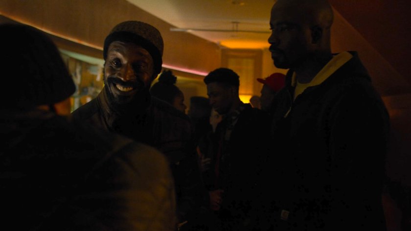 Luke approaches Turk in the Trouble and a Pair of Dice lounge.