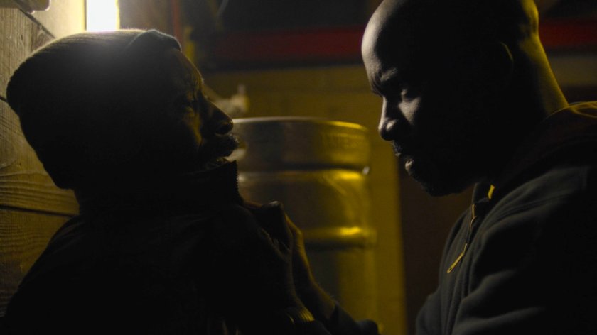 Luke threatens Turk in the Trouble and a Pair of Dice lounge.