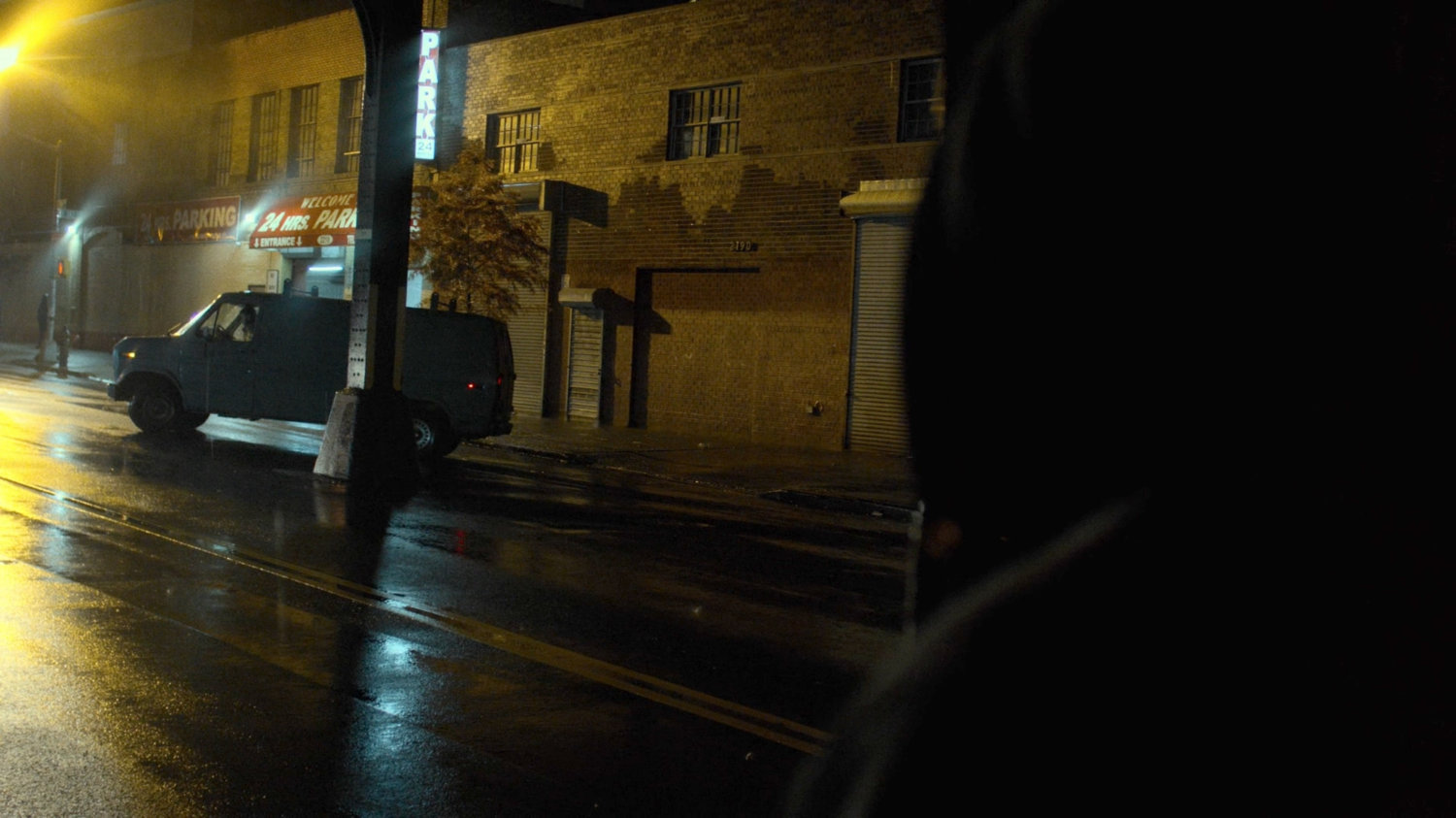 Luke spying on a van pulling up outside an Auto Glass store.