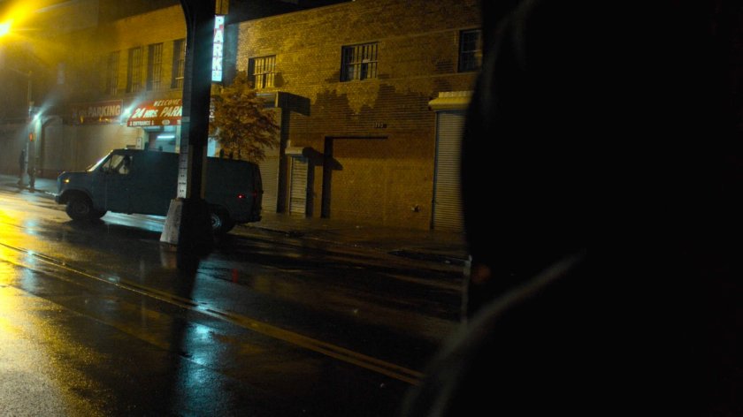 Luke spying on a van pulling up outside an Auto Glass store.