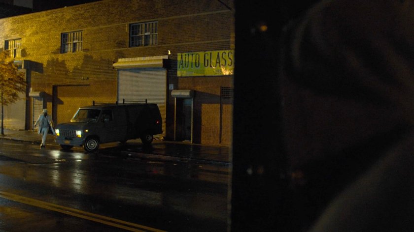 Luke spying on a van pulling up outside an Auto Glass store.