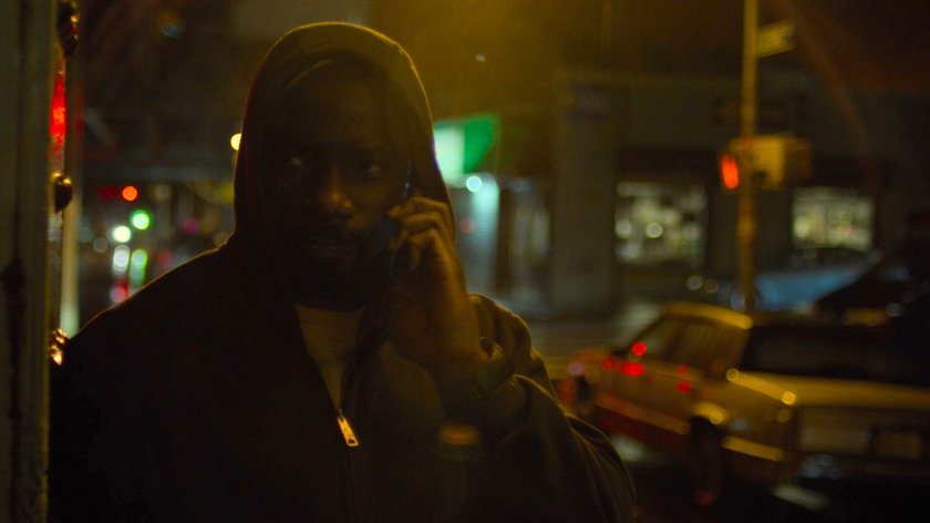 Luke on the phone on a dark street.