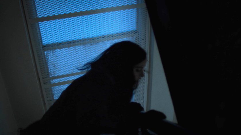 Jessica runs down the stairway in her building.