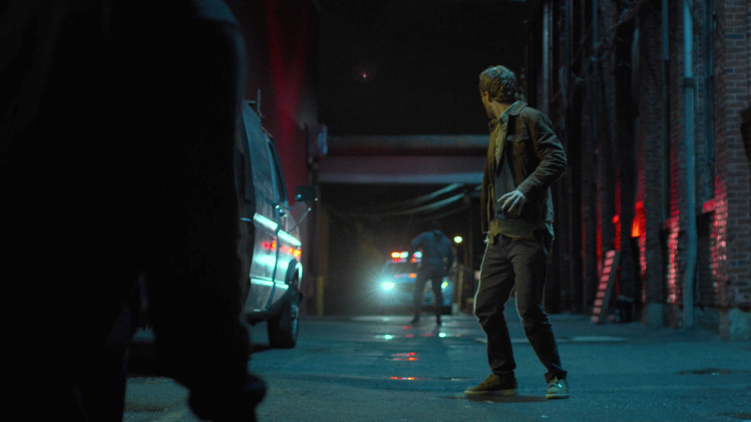 The police entering the alley behind Danny behind the Tsukamoto workshop.