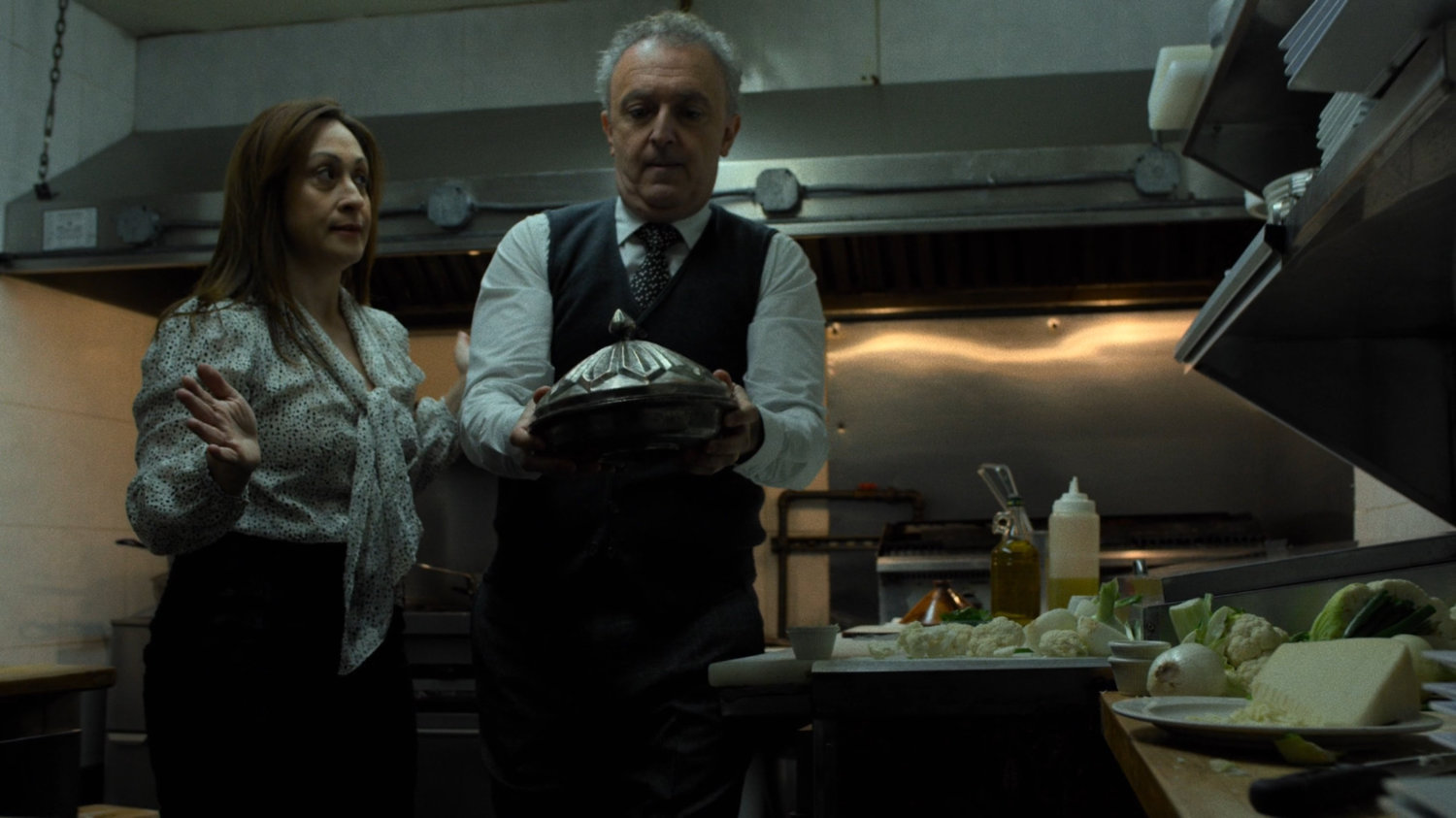 Husband and wife owners in the kitchen of their Turkish restaurant.