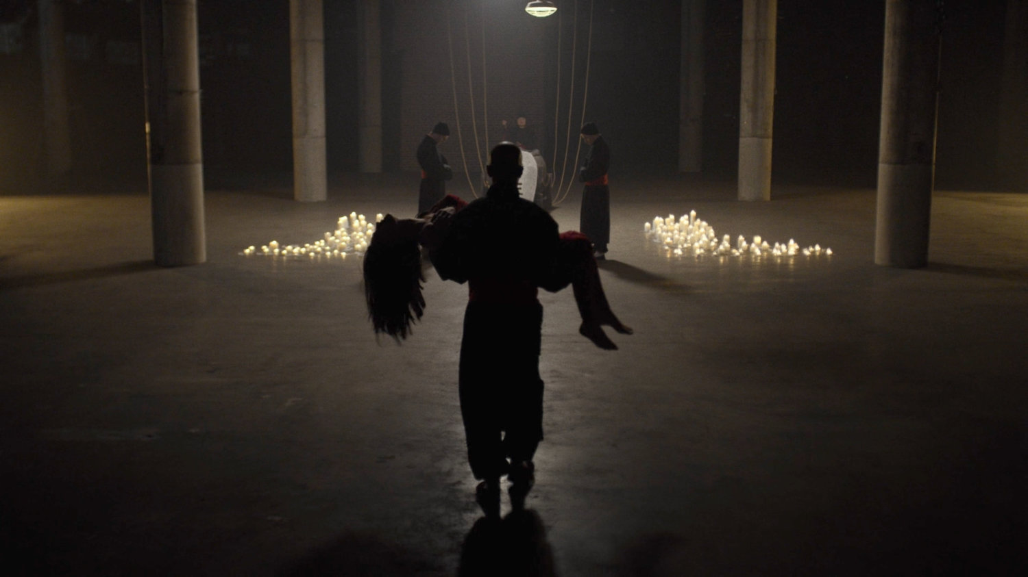 Hand member carrying body of Elektra towards resurrection sarcophagus in Hand warehouse.