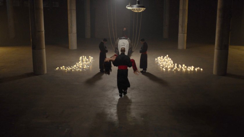 Hand member carrying body of Elektra towards resurrection sarcophagus in Hand warehouse.