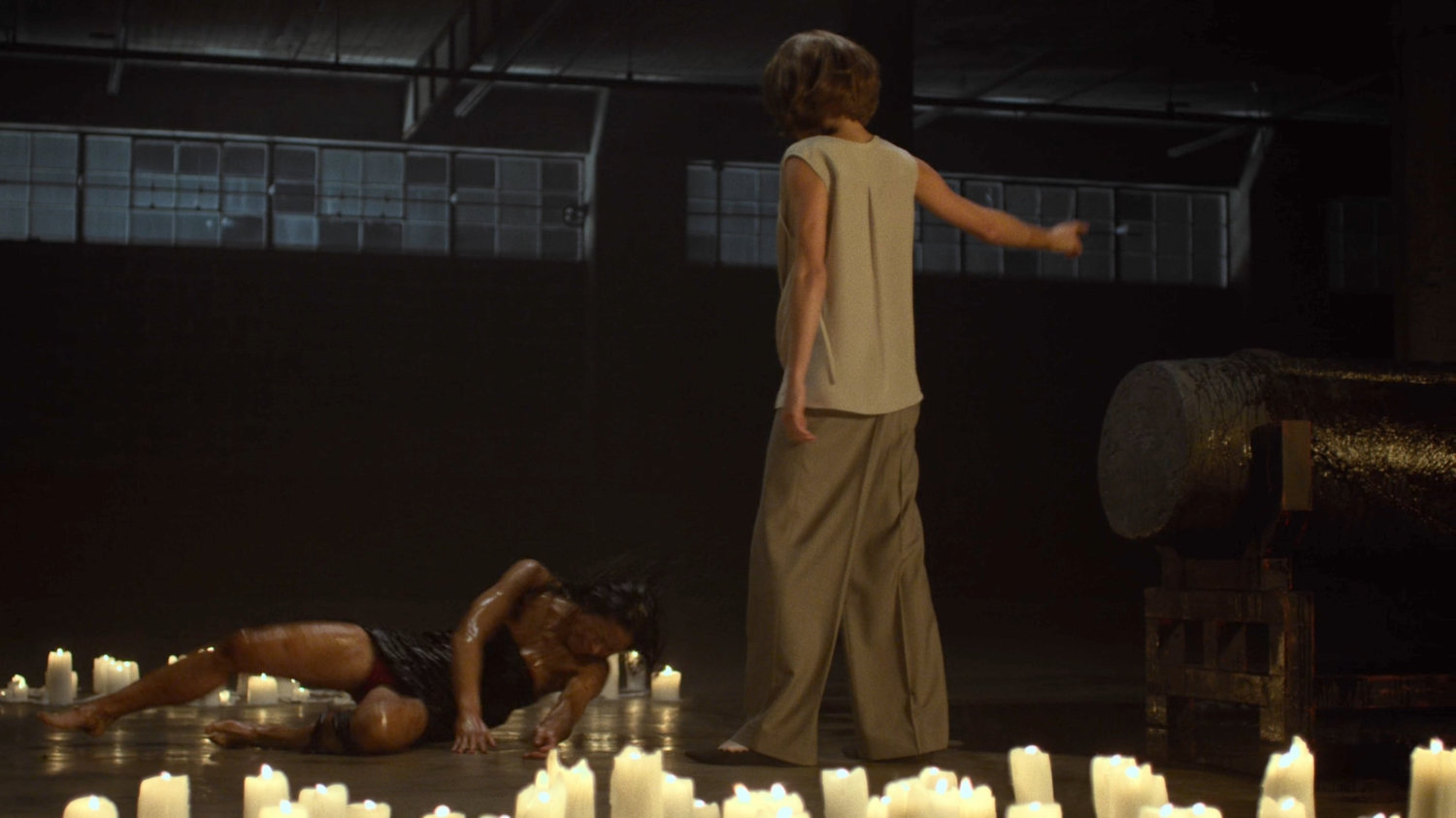 Alexandra standing over resurrected Elektra in Hand warehouse.