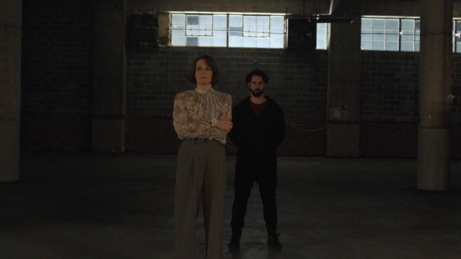 Alexandra and Hand Member look on in Hand Warehouse.