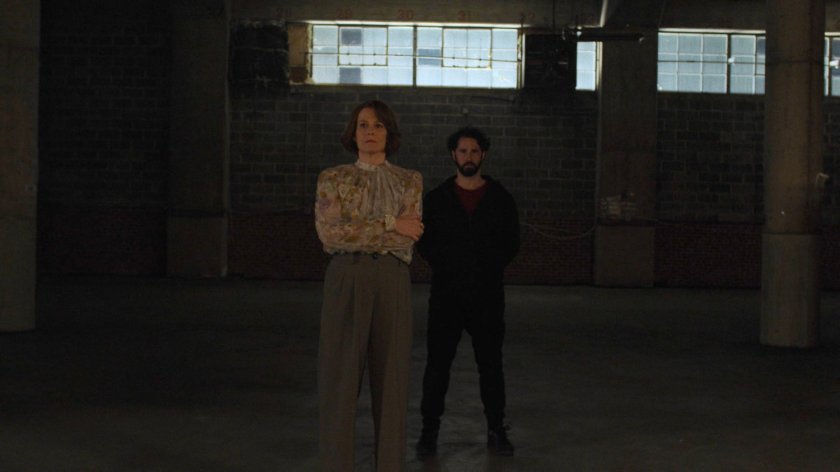 Alexandra and Hand Member look on in Hand Warehouse.