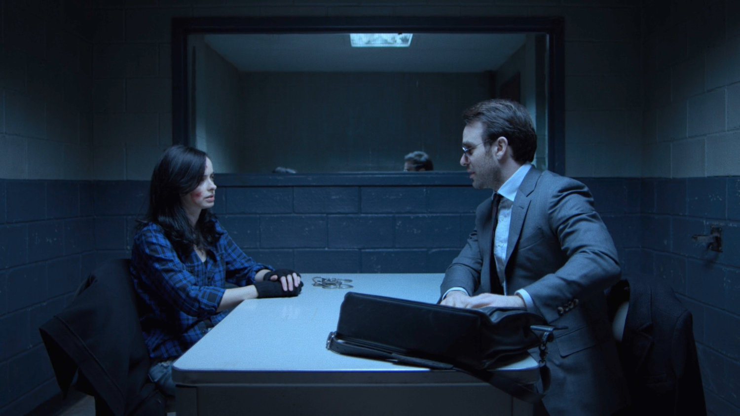 Matt and Jessica in a police interrogation room.