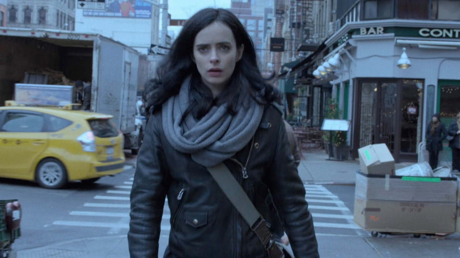 Jessica walking along a sidewalk.
