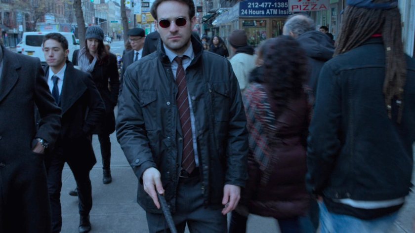Matt walking along crowded sidewalk.