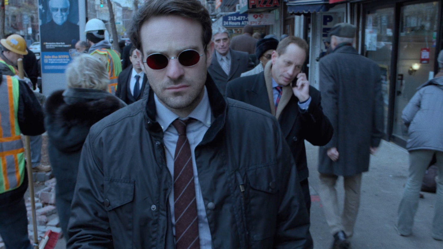 Matt walking along crowded sidewalk.