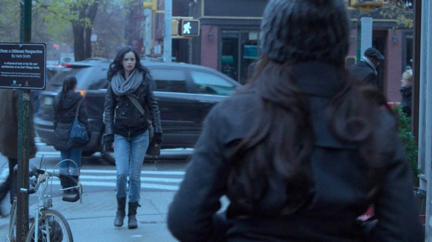 Jessica turning a corner on a sidewalk.