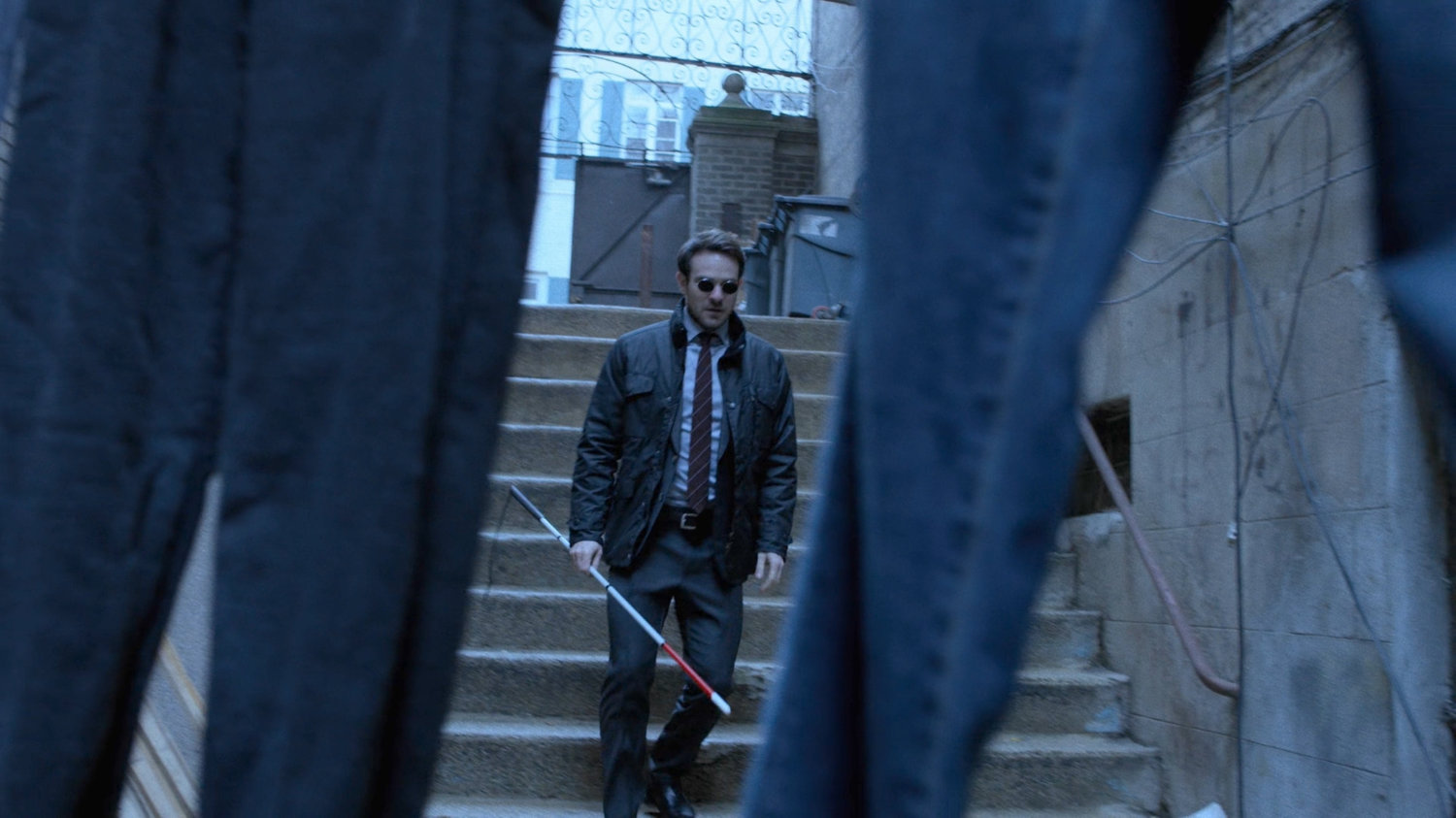 Matt descending stairs into an alley.