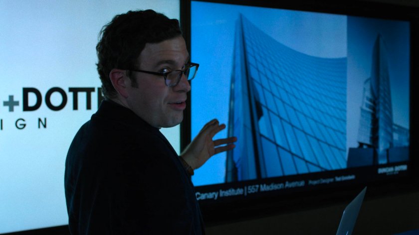 An architect at Duncan & Dotter Design shows Jessica some of their buildings.