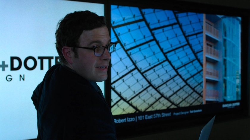 An architect at Duncan & Dotter Design shows Jessica some of their buildings.