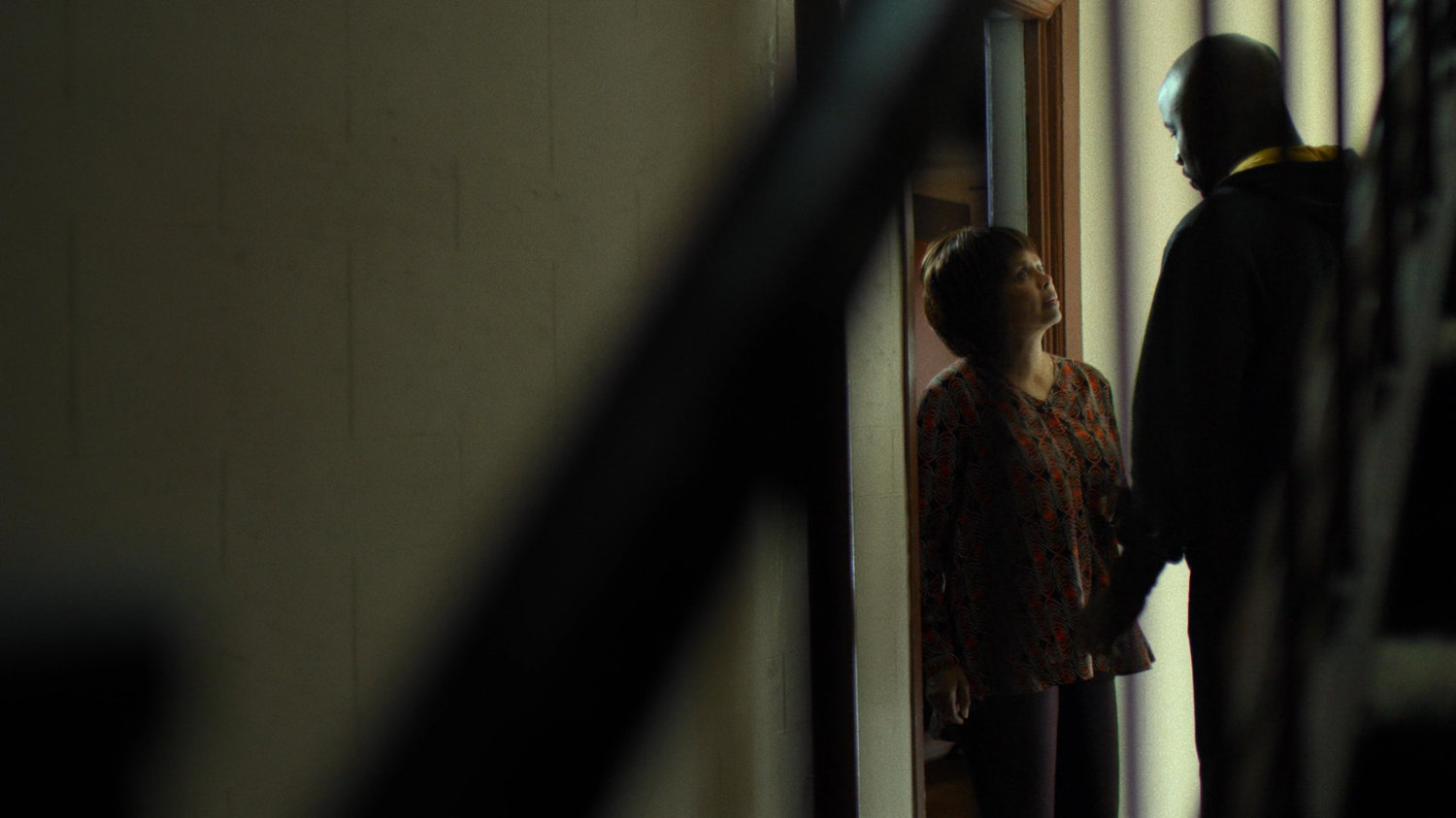 Luke speaks with Dolores Miller outside her apartment.