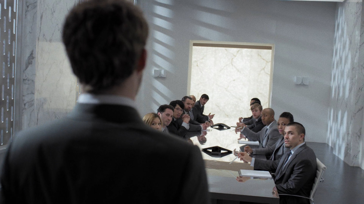 Danny enters boardroom of Midland Circle Financial skyscraper.