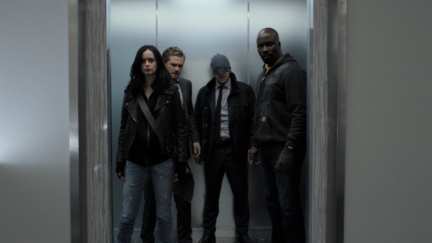 The Defenders in an elevator at Midland Circle Financial skyscraper.