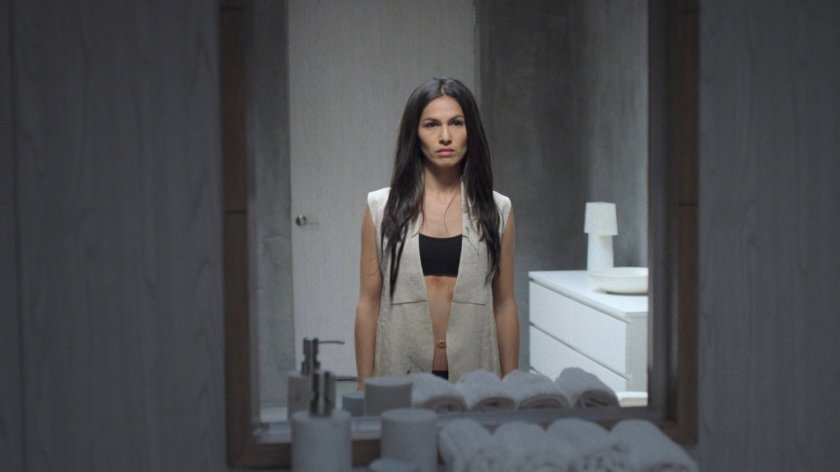 Elektra stares at herself in the mirror at the Hand compound.