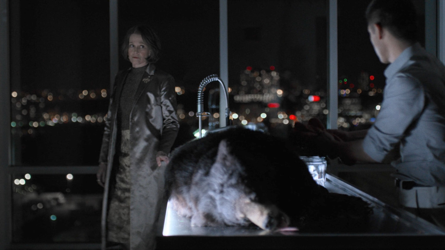 Murakami dissecting a moon bear in his workshop while talking to Alexandra.