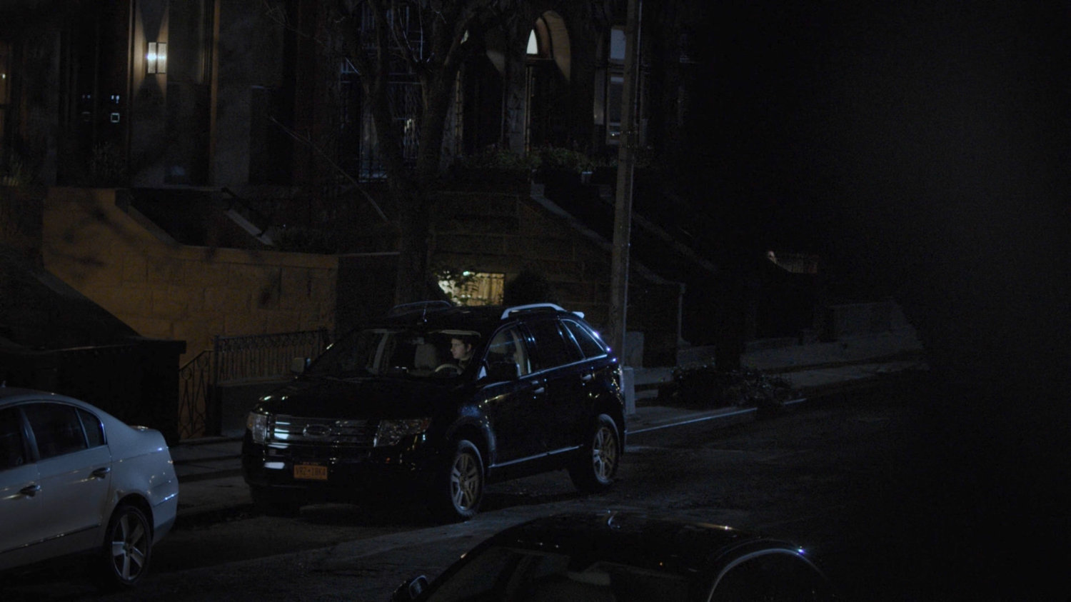 A car parked across the street from the Raymond brownstone.