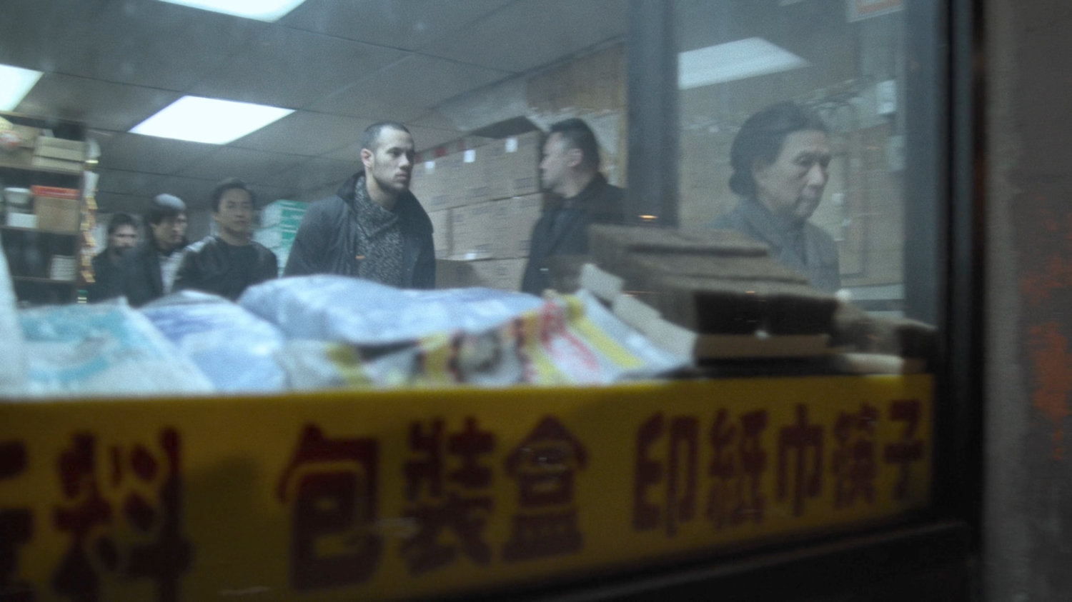 Madame Gao and her bodyguards exit a Chinese store.