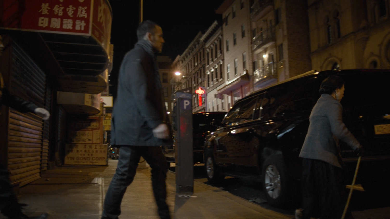 Madame Gao crosses a New York sidewalk.