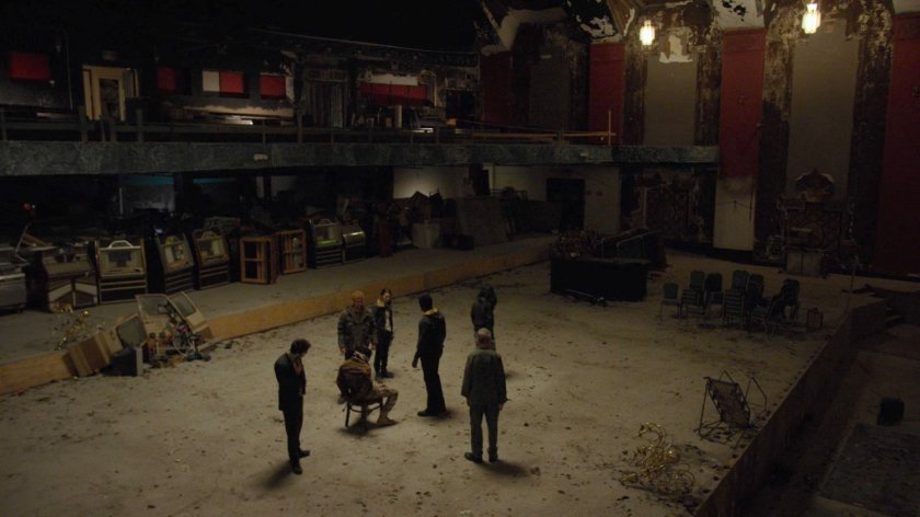 The Defenders surround a captured Sowande in a derelict theater.