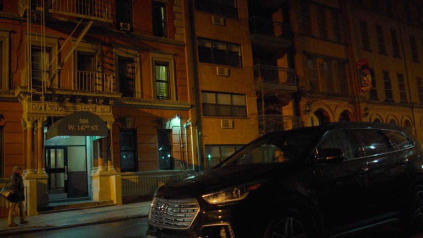 Exterior of Claire Temple's apartment building with car parked out front.