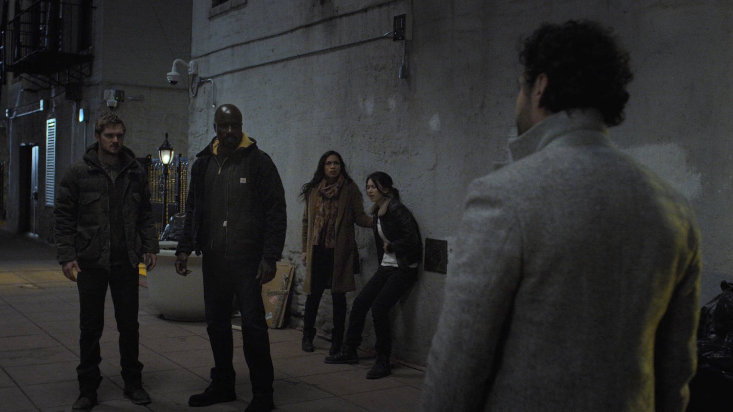Luke, Danny, Claire, and injured Colleen confront Bakuto in wide alley.