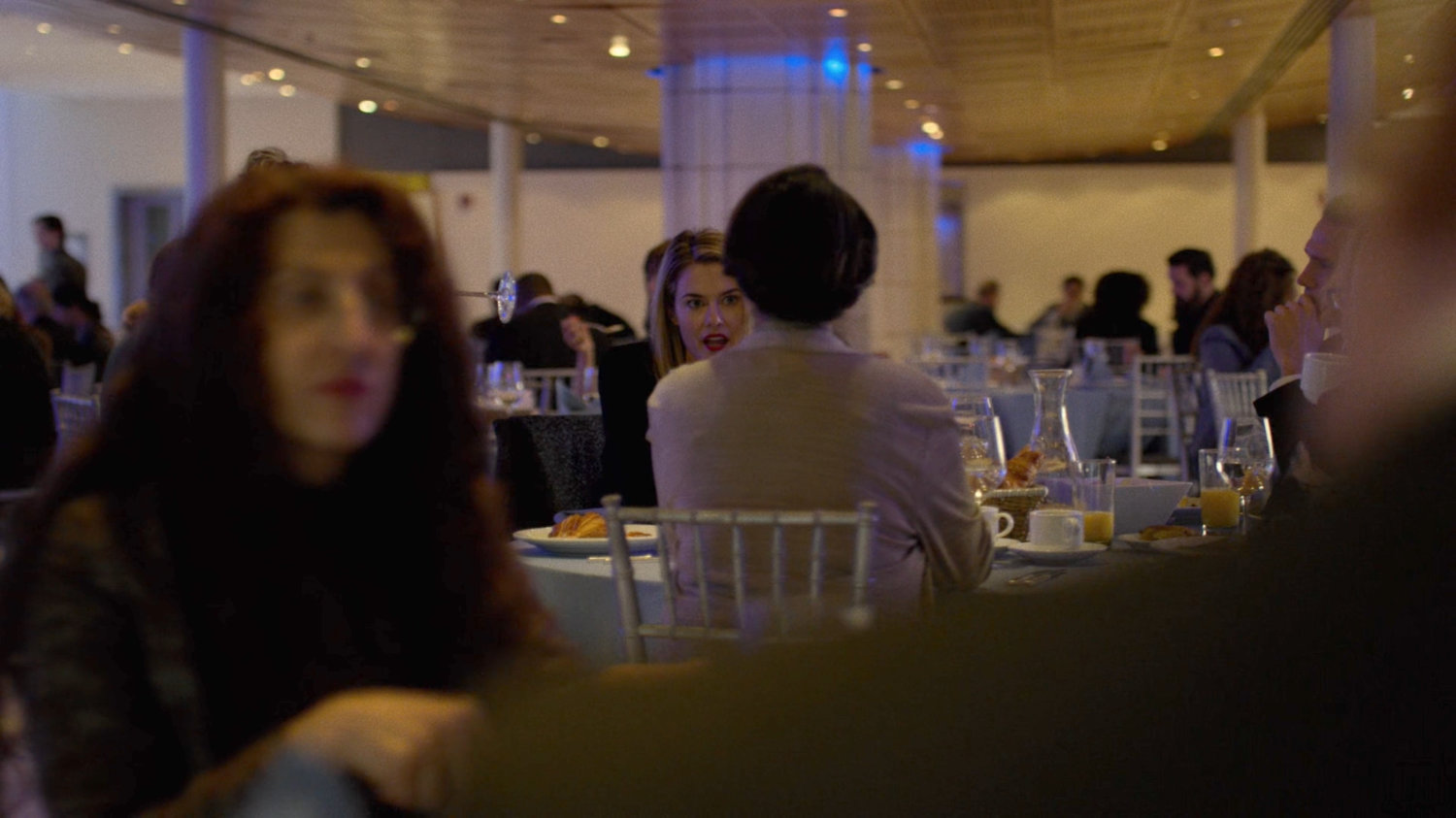 Trish meets with some investors at a fancy restaurant.
