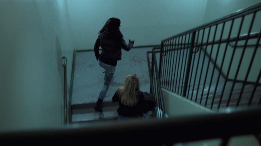 Jessica and Trish run up a stairway at a fancy restaurant.