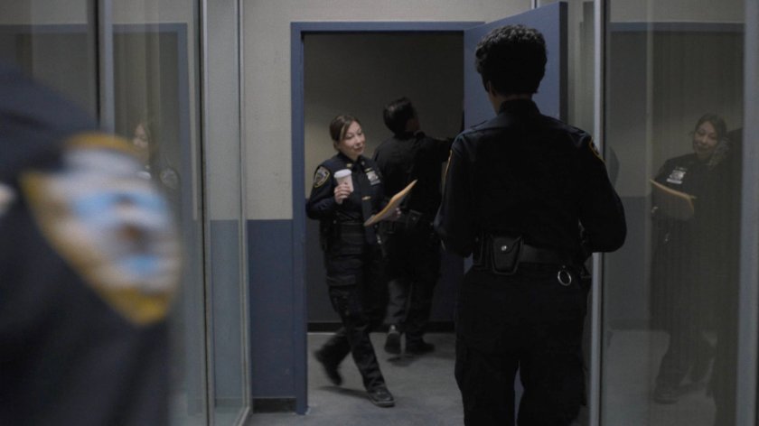 Police officers in 29th Precinct hallway.