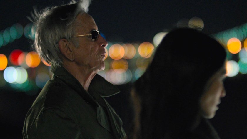 Stick and Elektra in a parking lot at night.