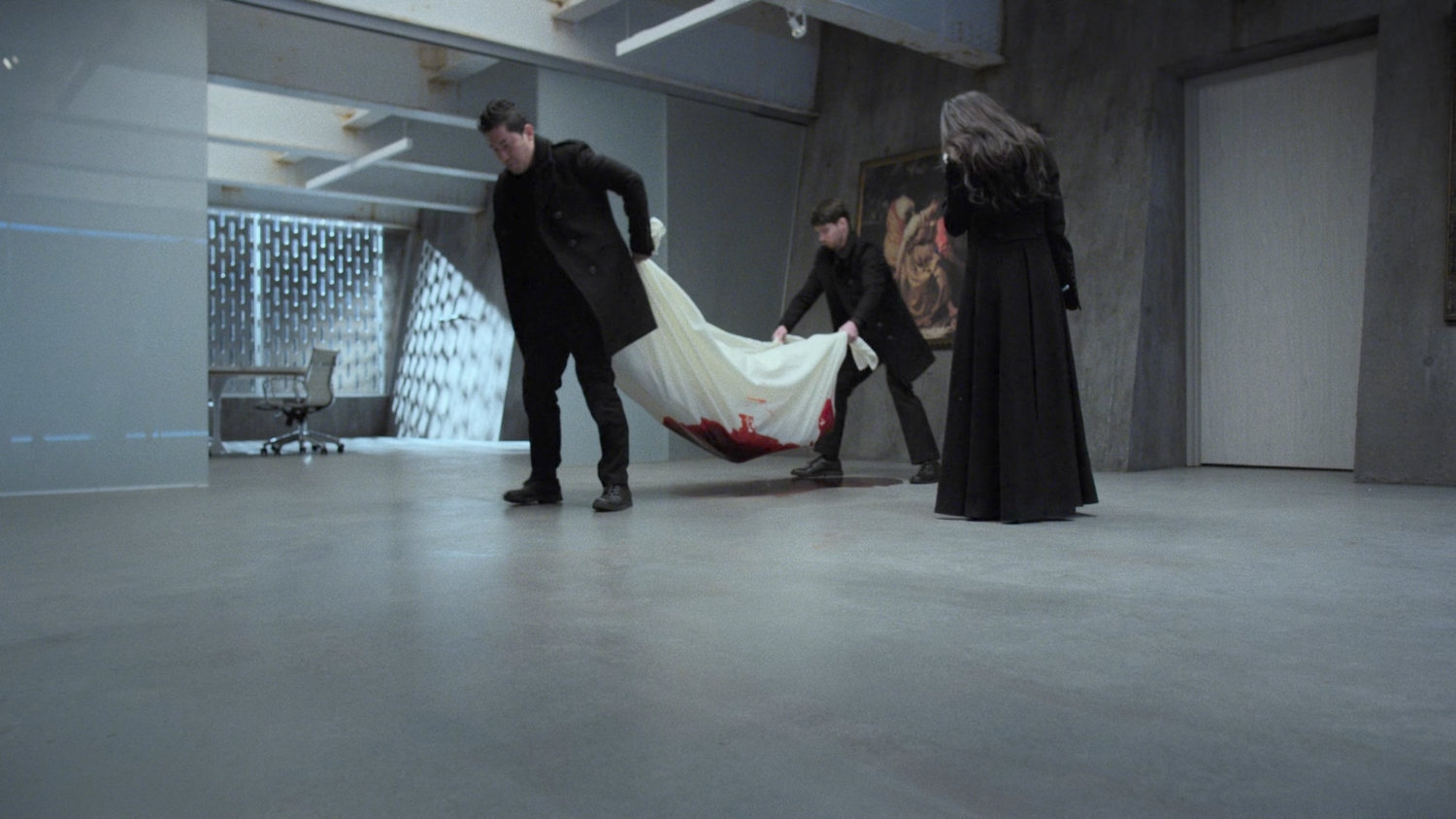 Hand guards move the dead body of Alexandra at the Hand Compound.