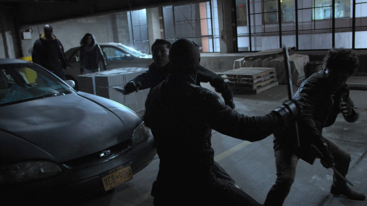 Daredevil fights Murakami and Bakuto in the Midland Circle parking garage while Jessica and Luke watch.