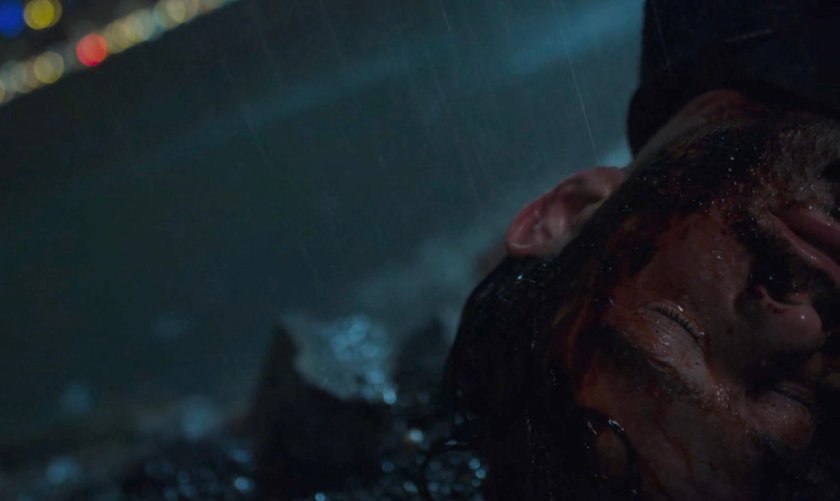 Matt Murdock on the edge of a river at night in the rain.